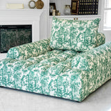 Joey Twal chaise lounge featuring a plush, oversized design upholstered in a striking green and white toile print fabric. The chaise showcases deep button tufting, a high backrest, and ample seating space, perfect for comfortable relaxation in sophisticated interiors