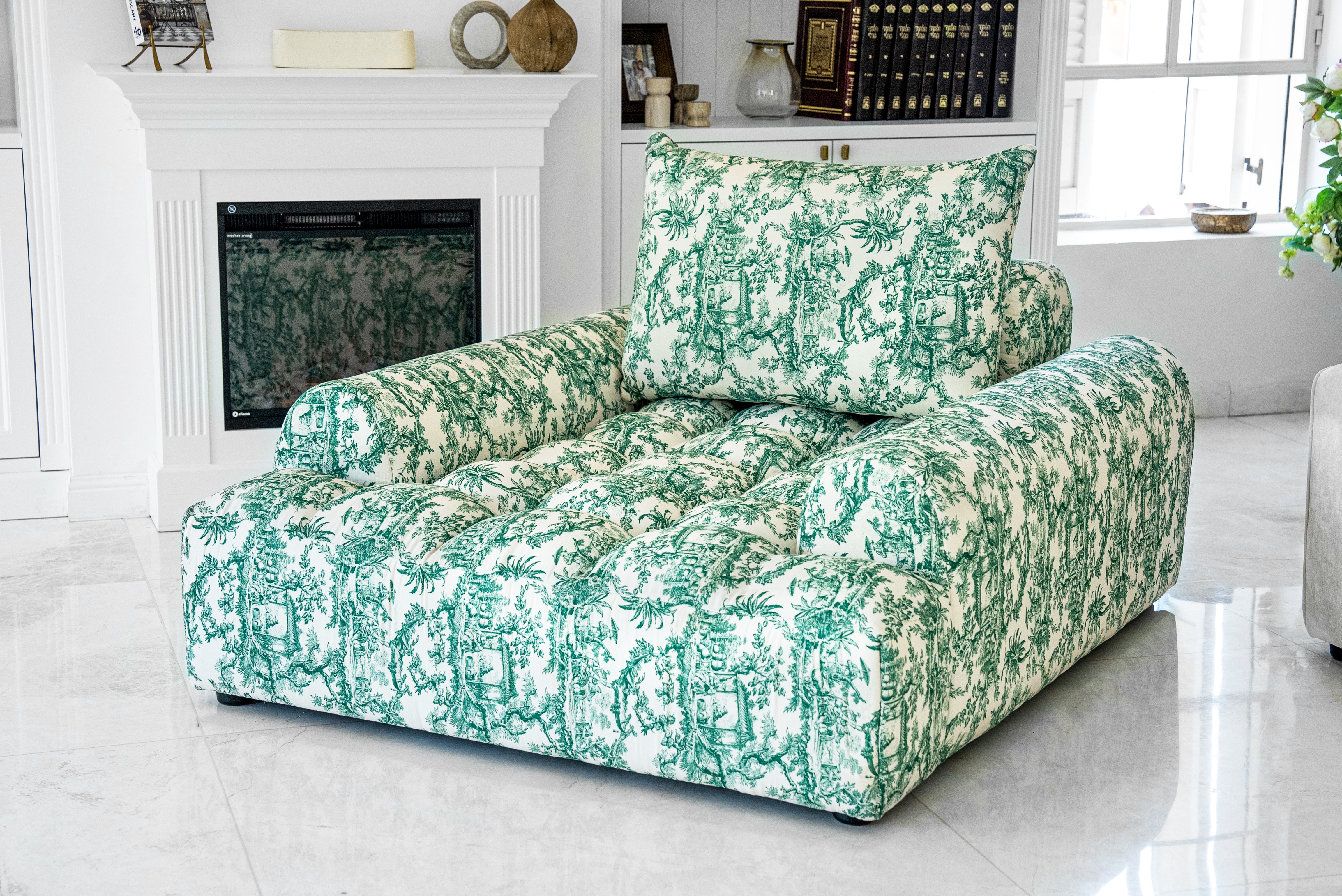 Joey Twal chaise lounge featuring a plush, oversized design upholstered in a striking green and white toile print fabric. The chaise showcases deep button tufting, a high backrest, and ample seating space, perfect for comfortable relaxation in sophisticated interiors